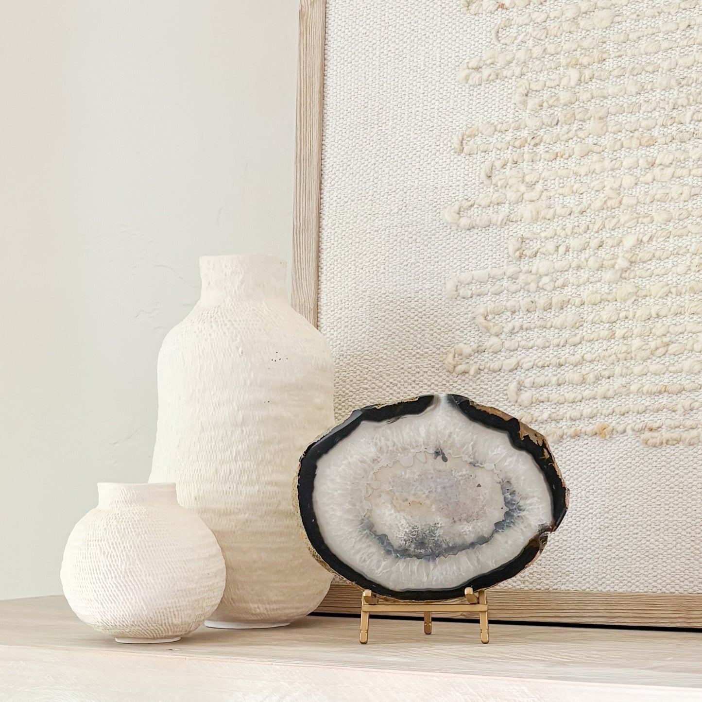 Natural Brazilian agate slice sculpture on stand with unique mineral patterns and organic texture