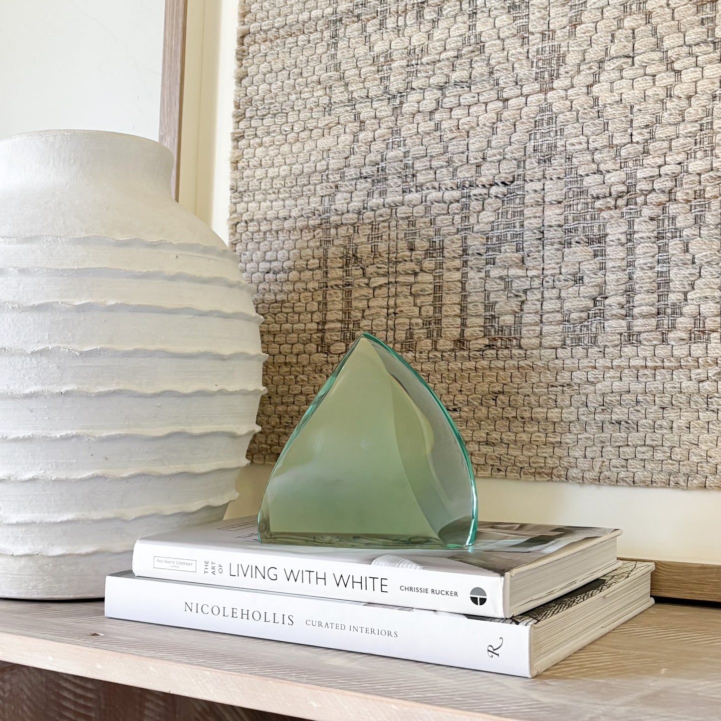 Handcrafted green glass art sculpture with smooth curved silhouette