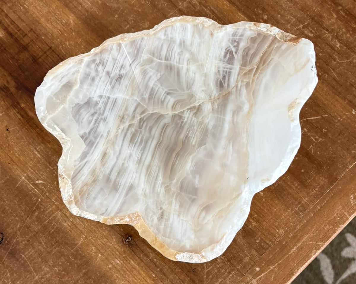 Natural amber onyx bowl with distinctive mineral banding and polished finish