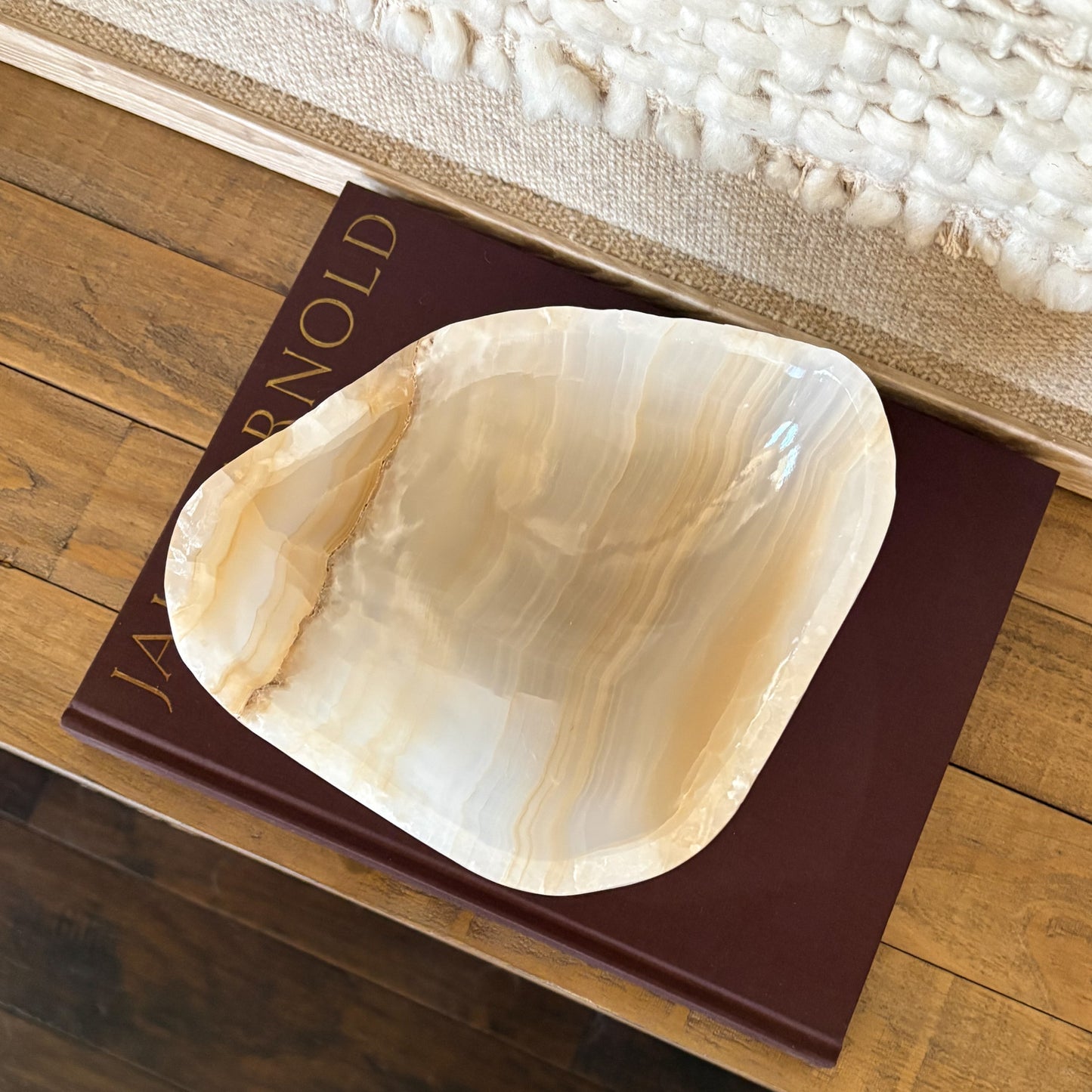 Artisan hand carved amber onyx bowl featuring unique natural stone patterns