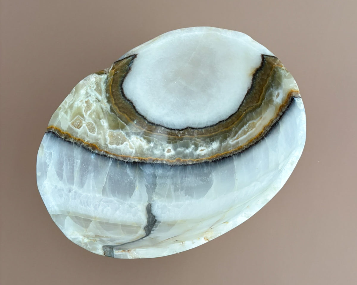 Interior of olive onyx decorative bowl showing natural stone banding and unique mineral patterns