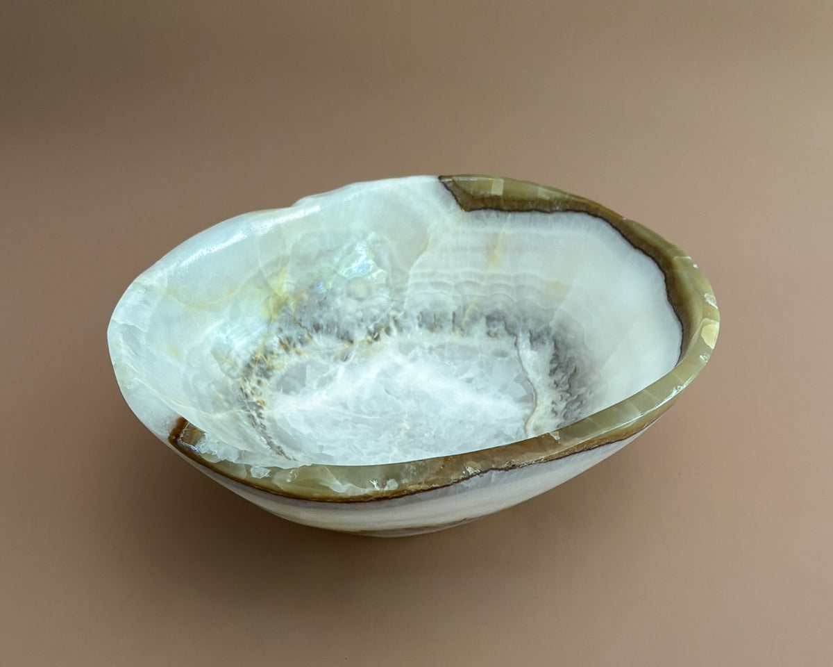 Interior of olive onyx decorative bowl showing natural stone banding and unique mineral patterns