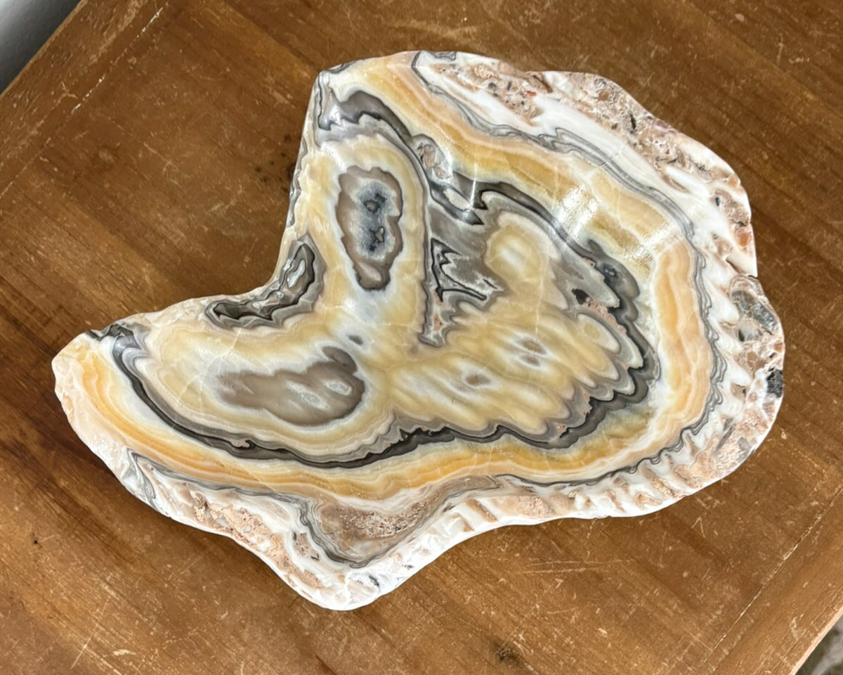Close-up of hand-carved zebra onyx bowl highlighting intricate natural veining and color variations