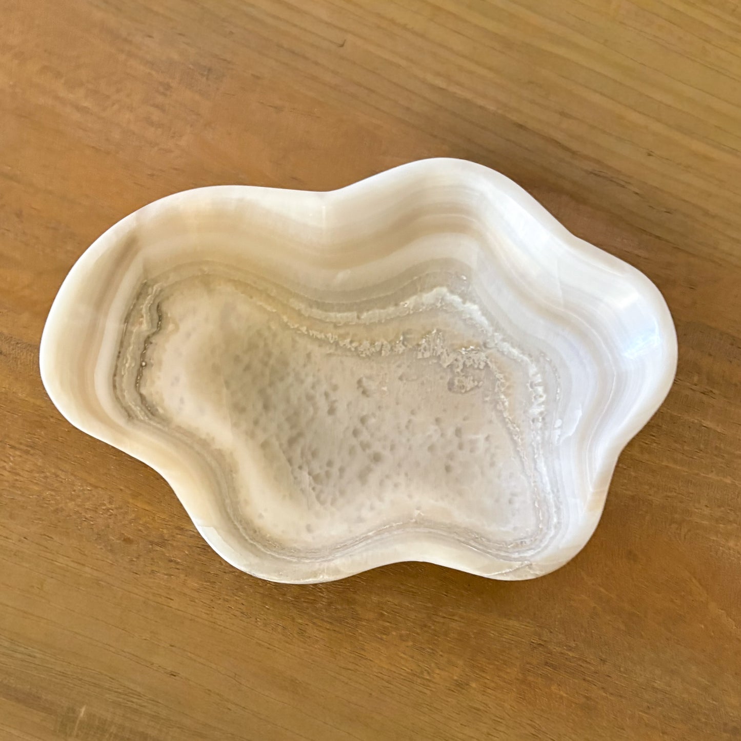 Artisan carved grey onyx bowl showcasing organic stone textures