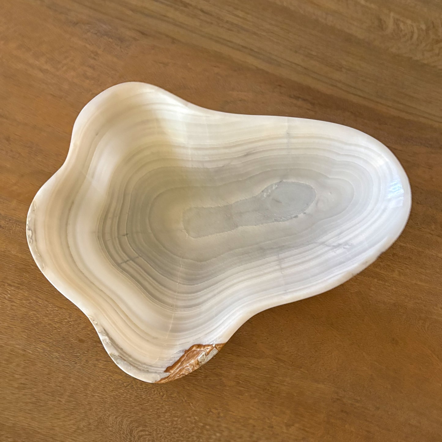 Large carved grey onyx bowl with natural stone patterns and polished finish