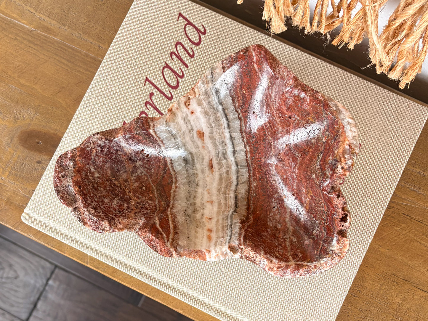 Deep pink serpentine stone bowl with distinctive cream and crimson veining