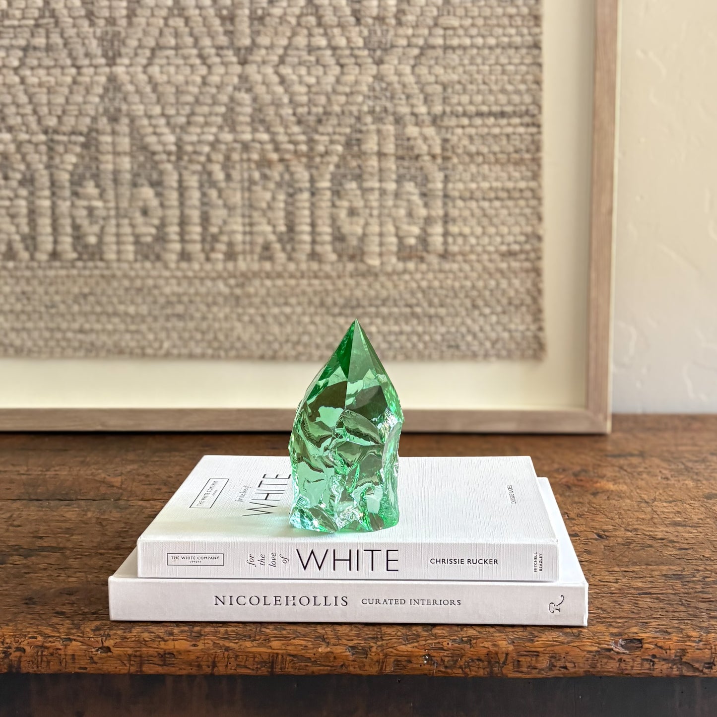 Artisan green glass point styled on White coffee table books