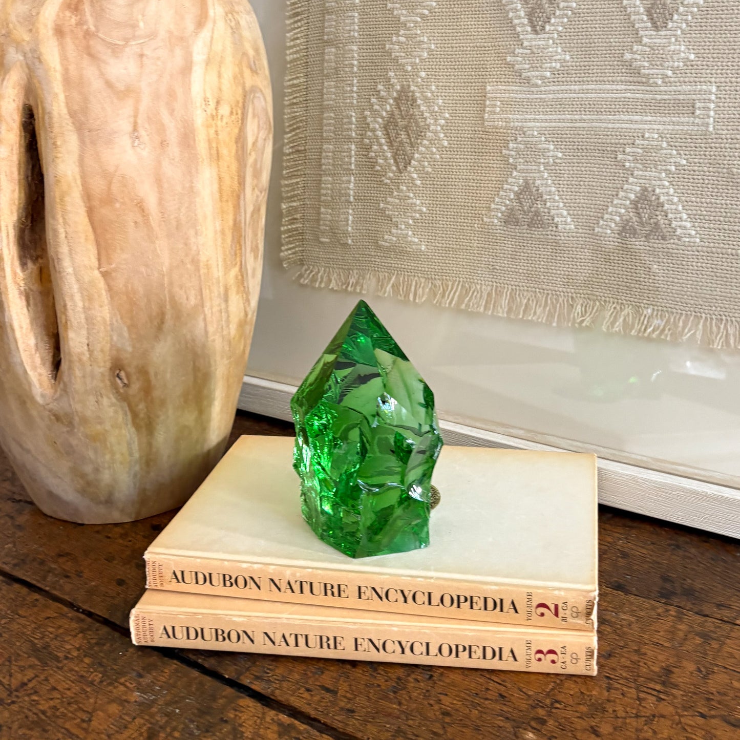 Rustic green glass point displayed on vintage Audubon Nature Encyclopedia books
