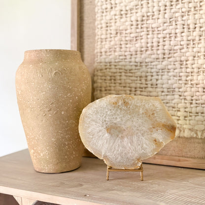Large polished Brazilian agate slab display on stand featuring natural earth tone crystal patterns