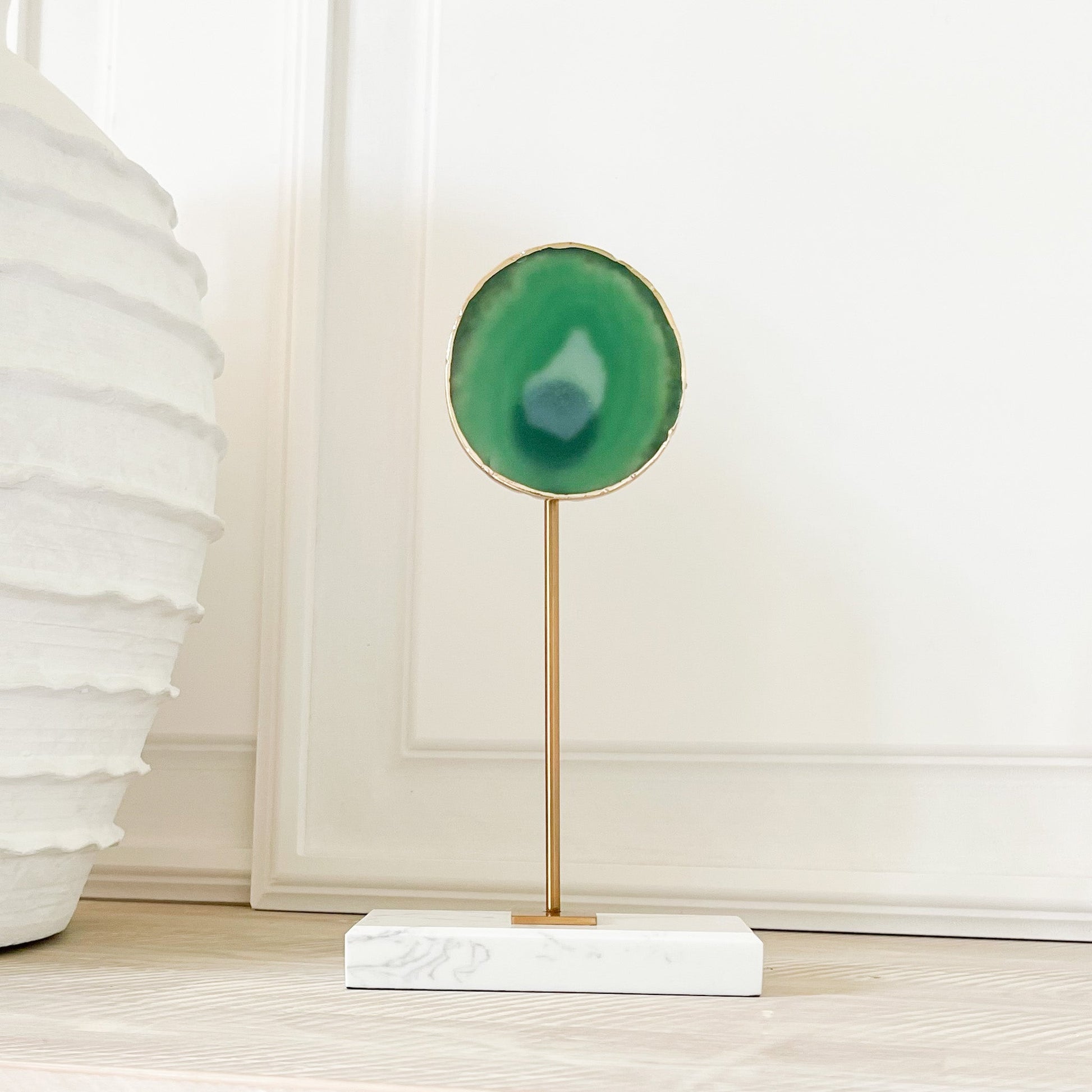 green agate silce on marble and brass stand