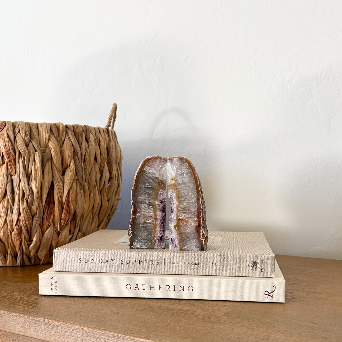 agate geode crystal on top of two books with a woven basket in the background