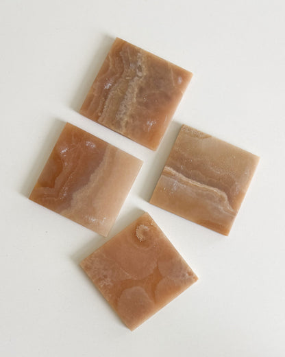Decorative amber onyx coaster set featuring unique natural stone patterns