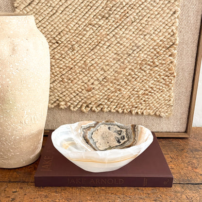 Close up of hand carved amber onyx bowl showing natural stone veining and polished finish