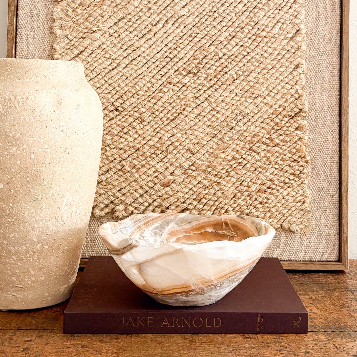 Hand carved amber onyx bowl styled on modern rustic table