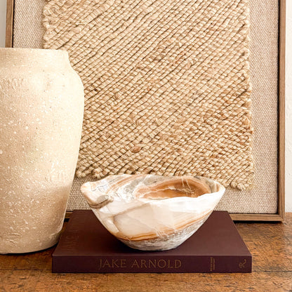 Hand carved amber onyx bowl styled on modern rustic table