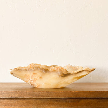 Organic shaped amber onyx stone bowl hand carved with polished translucent finish