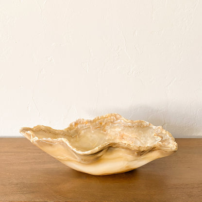 Artisan carved amber onyx decorative bowl with sculptural raw edge design