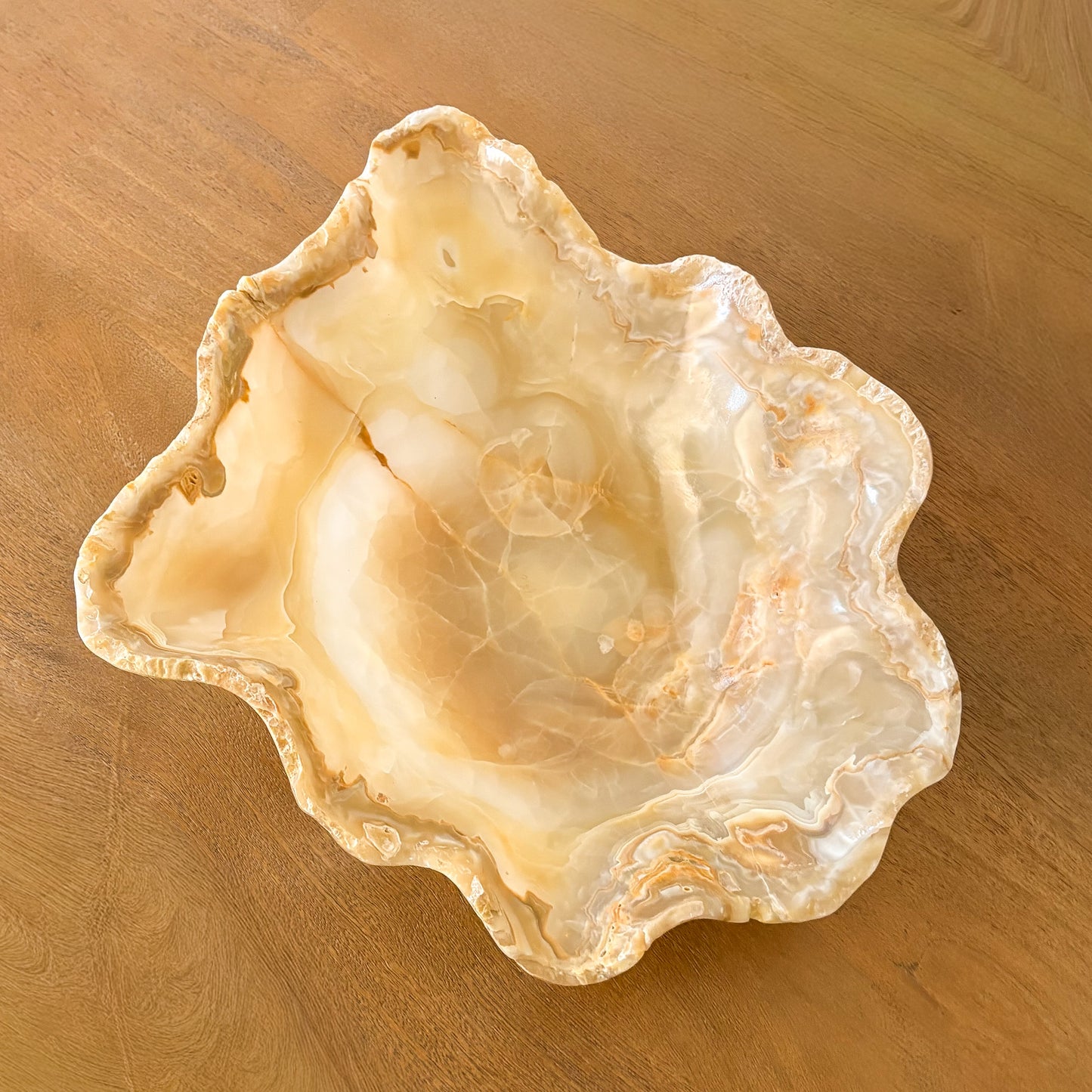 Modern rustic amber onyx stone bowl styled on wood console table