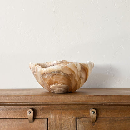 Oversized carved amber onyx stone bowl with natural marble striations