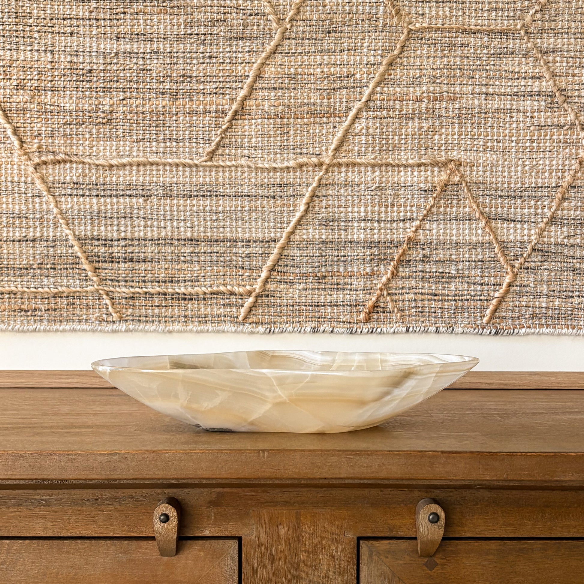 Hand carved onyx stone bowl in warm amber and cream tones