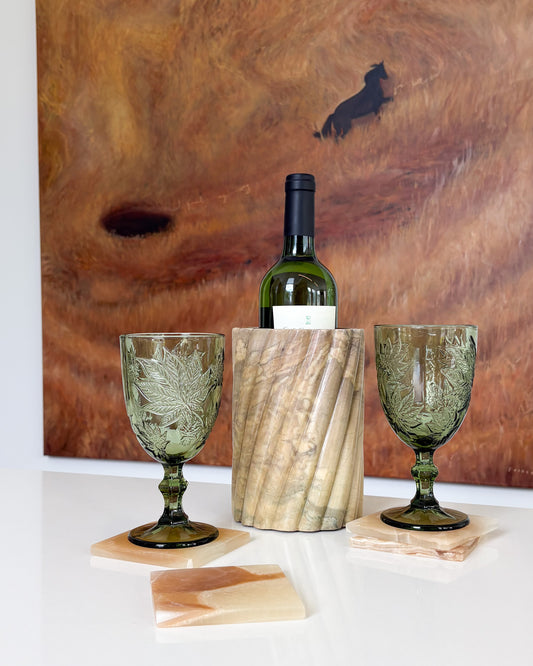 Set of four amber onyx stone coasters with natural golden and cream veining