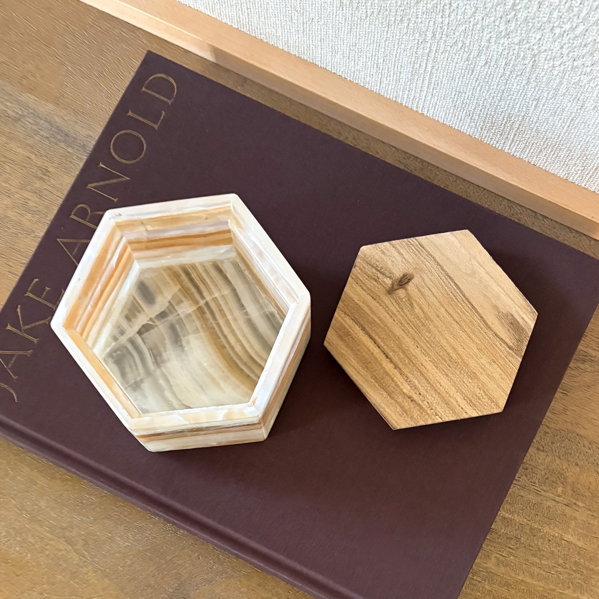 Close-up of amber onyx hexagonal box featuring warm orange tones and smooth wooden lid