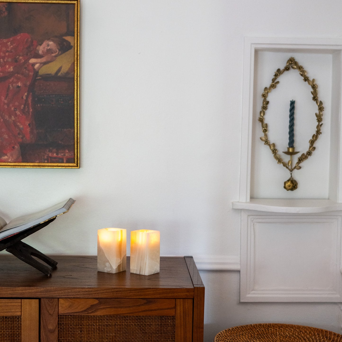 Warm glowing tealight candles in polished amber onyx holders
