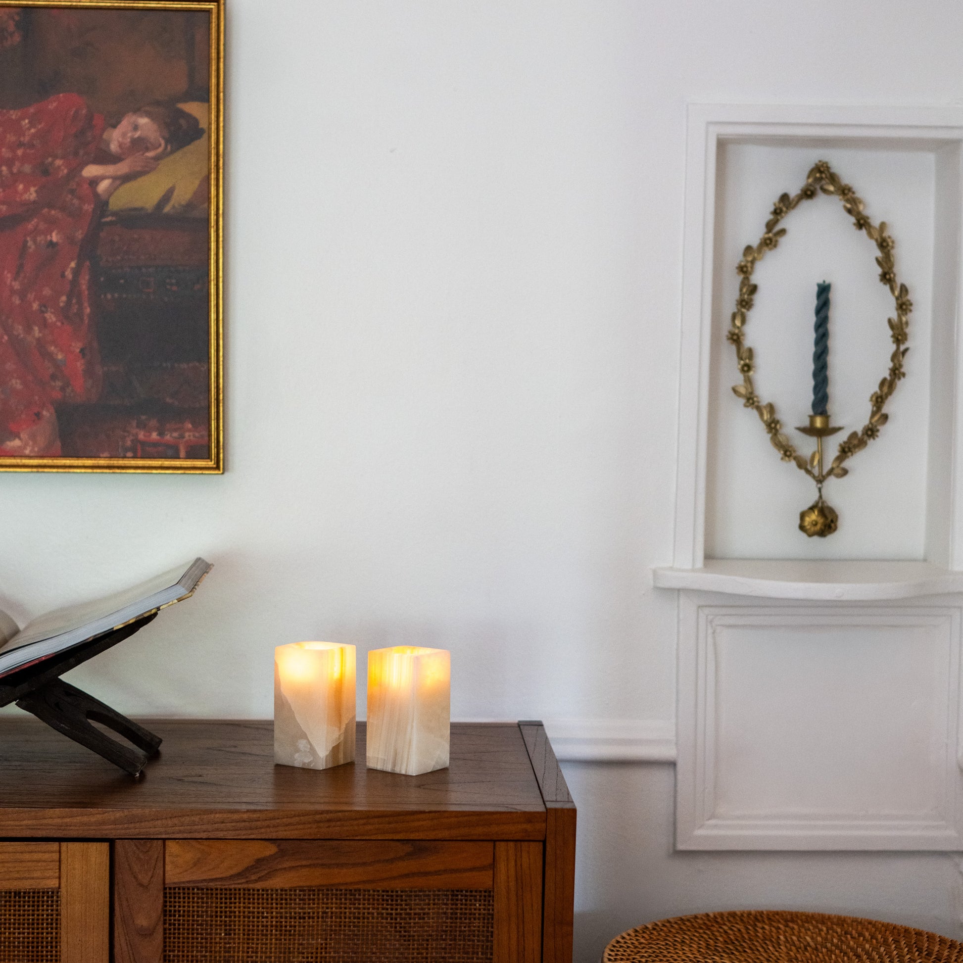 Warm glowing tealight candles in polished amber onyx holders