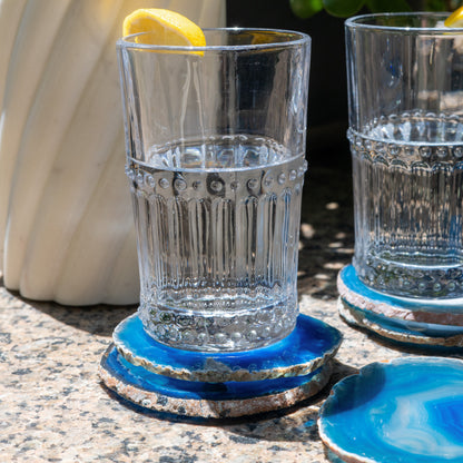Natural Brazilian agate drink coasters enhanced with a vibrant blue hue for modern organic home décor