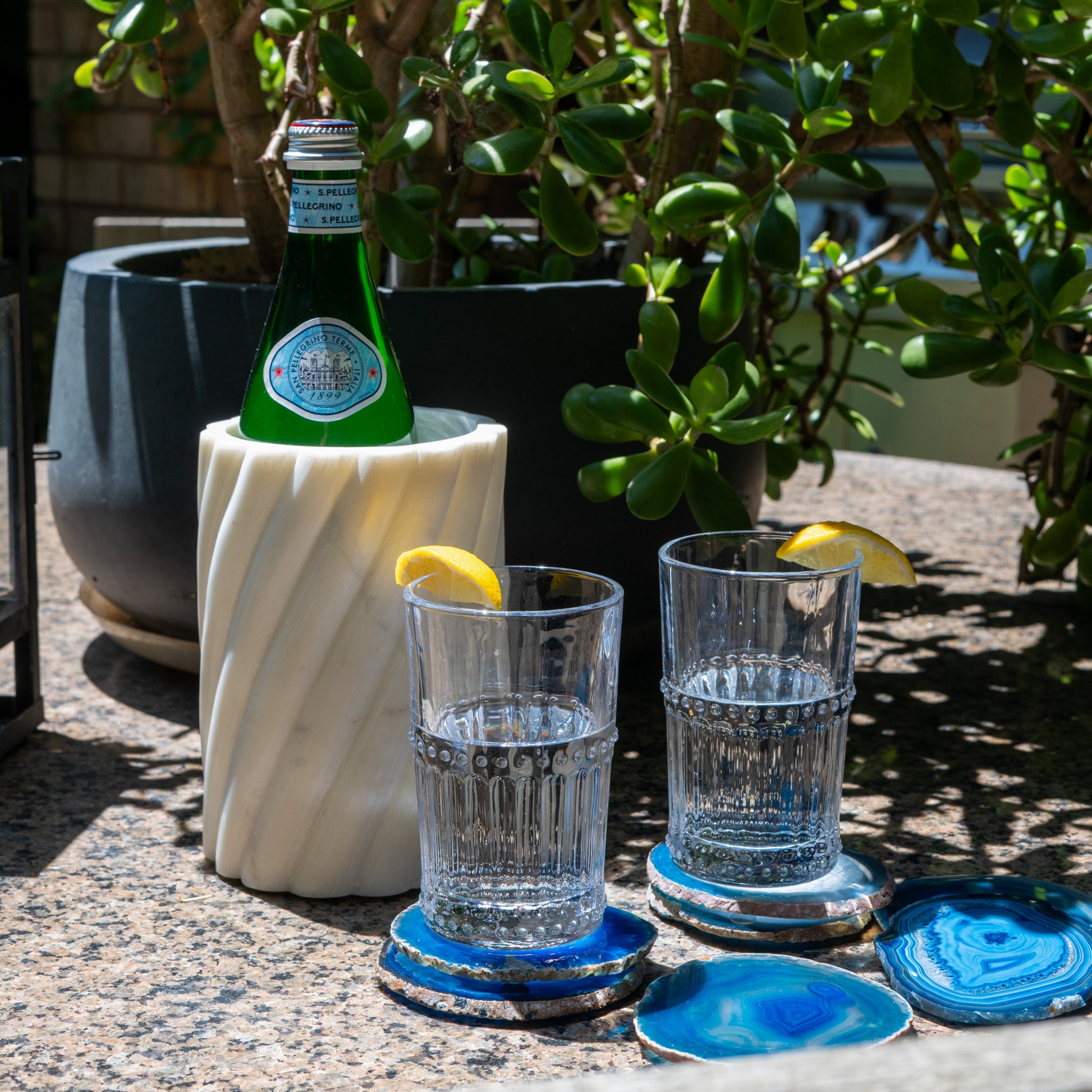 Hand-polished blue Brazilian agate coasters featuring enhanced vibrant color and unique natural stone patterns.