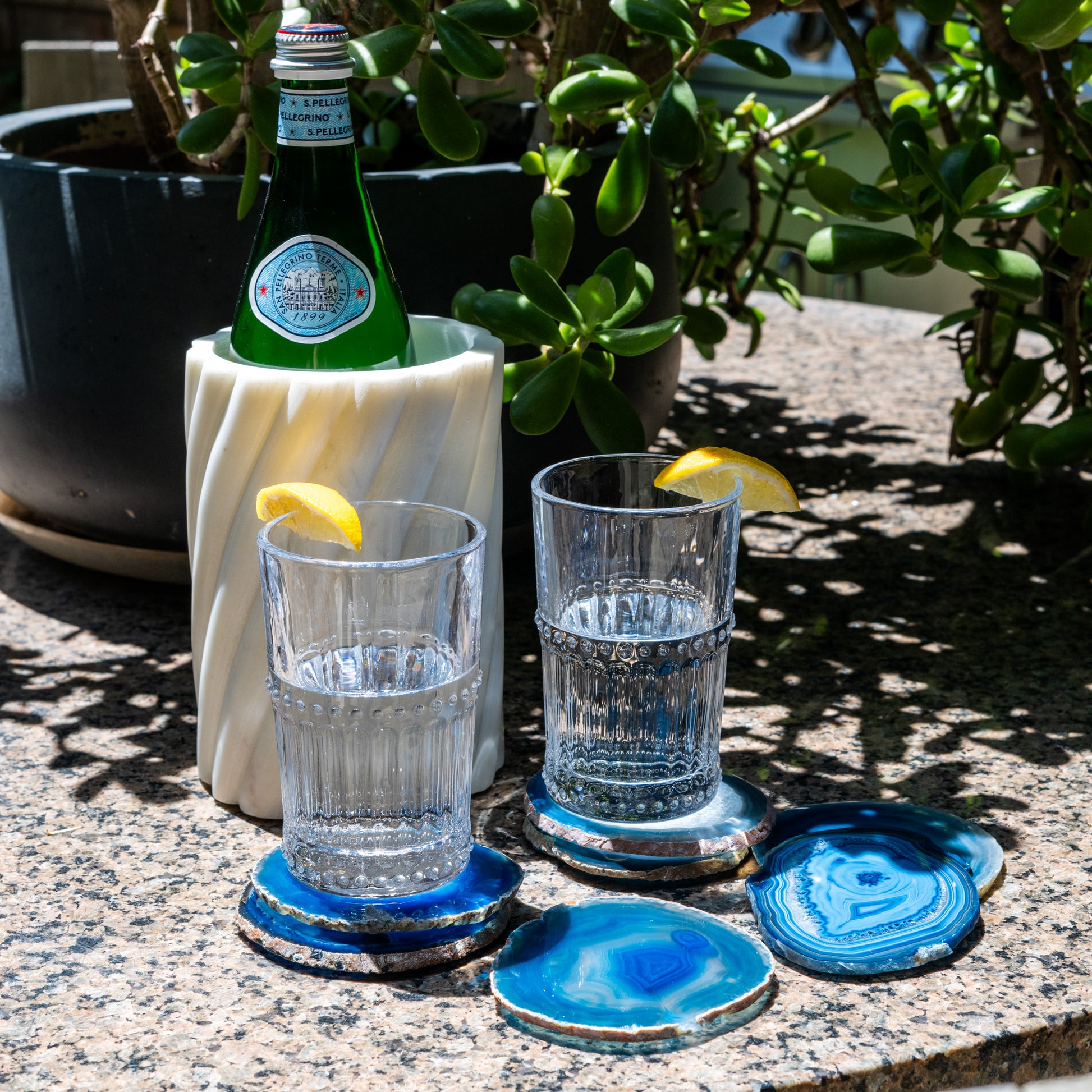 One-of-a-kind blue agate coaster set with polished natural stone and distinctive banded patterns.