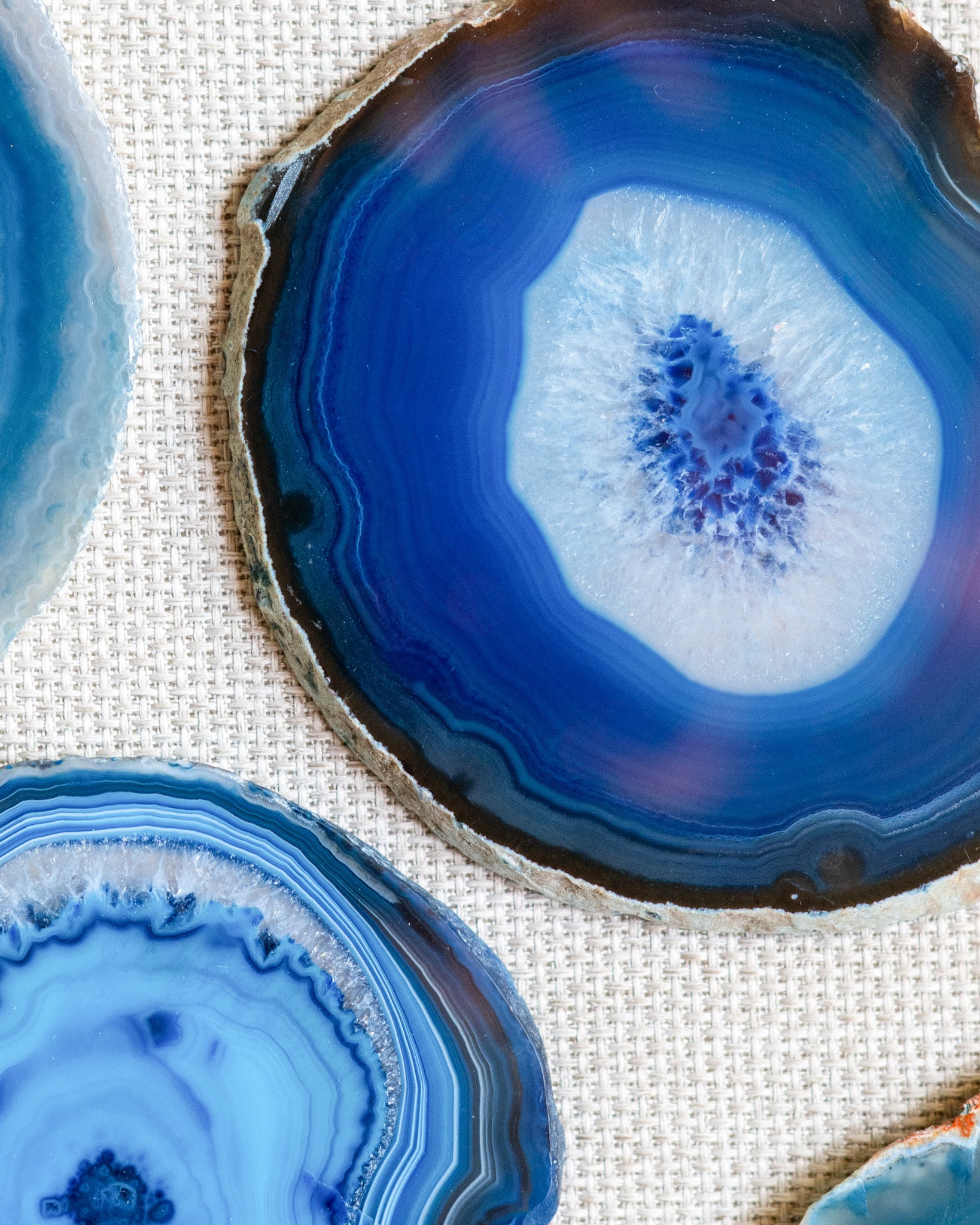 Blue Brazilian agate coasters displayed on a coffee table as elegant natural stone home accessories.