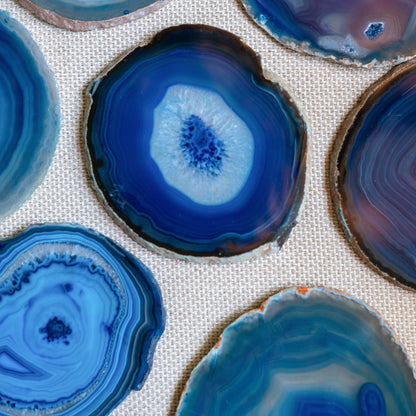 Luxury Brazilian agate coaster set in vibrant blue with natural crystalline formations and organic banding.