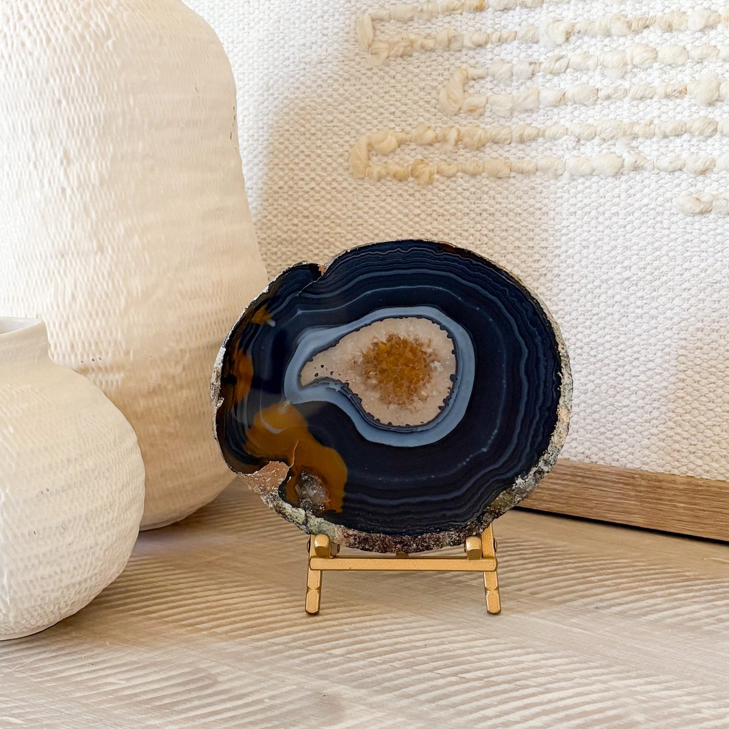 blue and brown decorative agate slice on brass easel stand