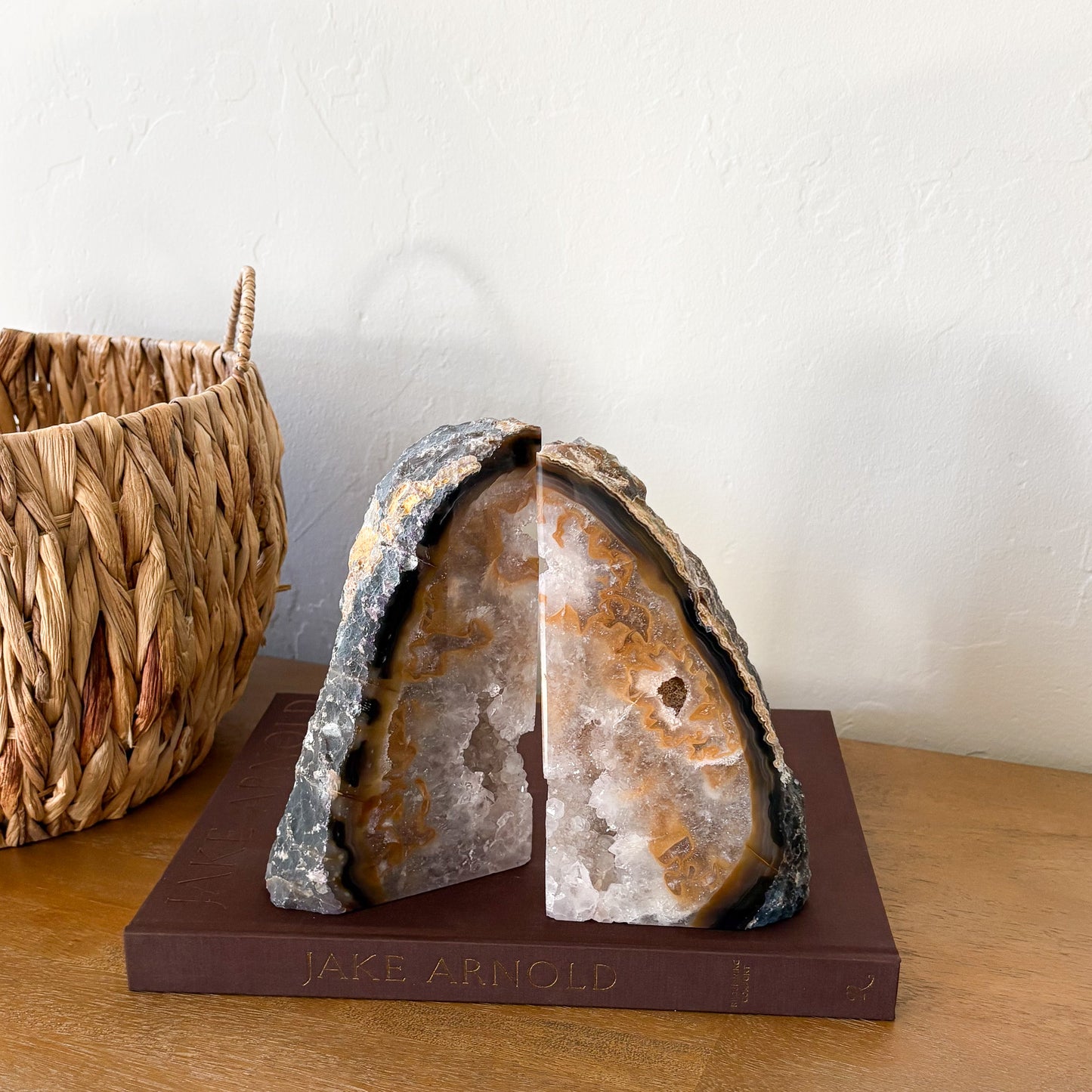 Natural Brazilian agate geode bookend set with amber and charcoal banded edges and raw quartz crystal center for luxury home decor