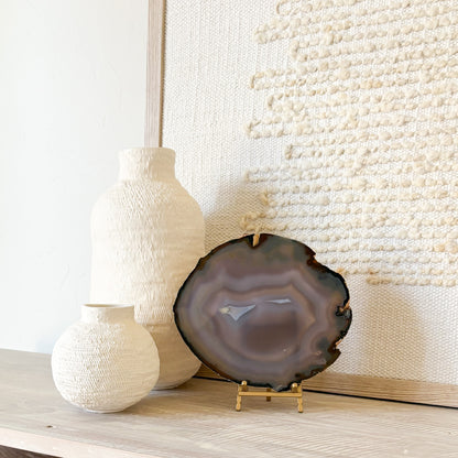 Decorative Brazilian agate slice with natural crystal banding on metal stand