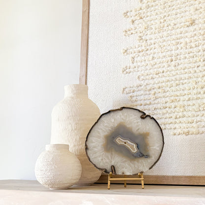 Natural Brazilian agate crystal slice displayed on metal stand elegant decor