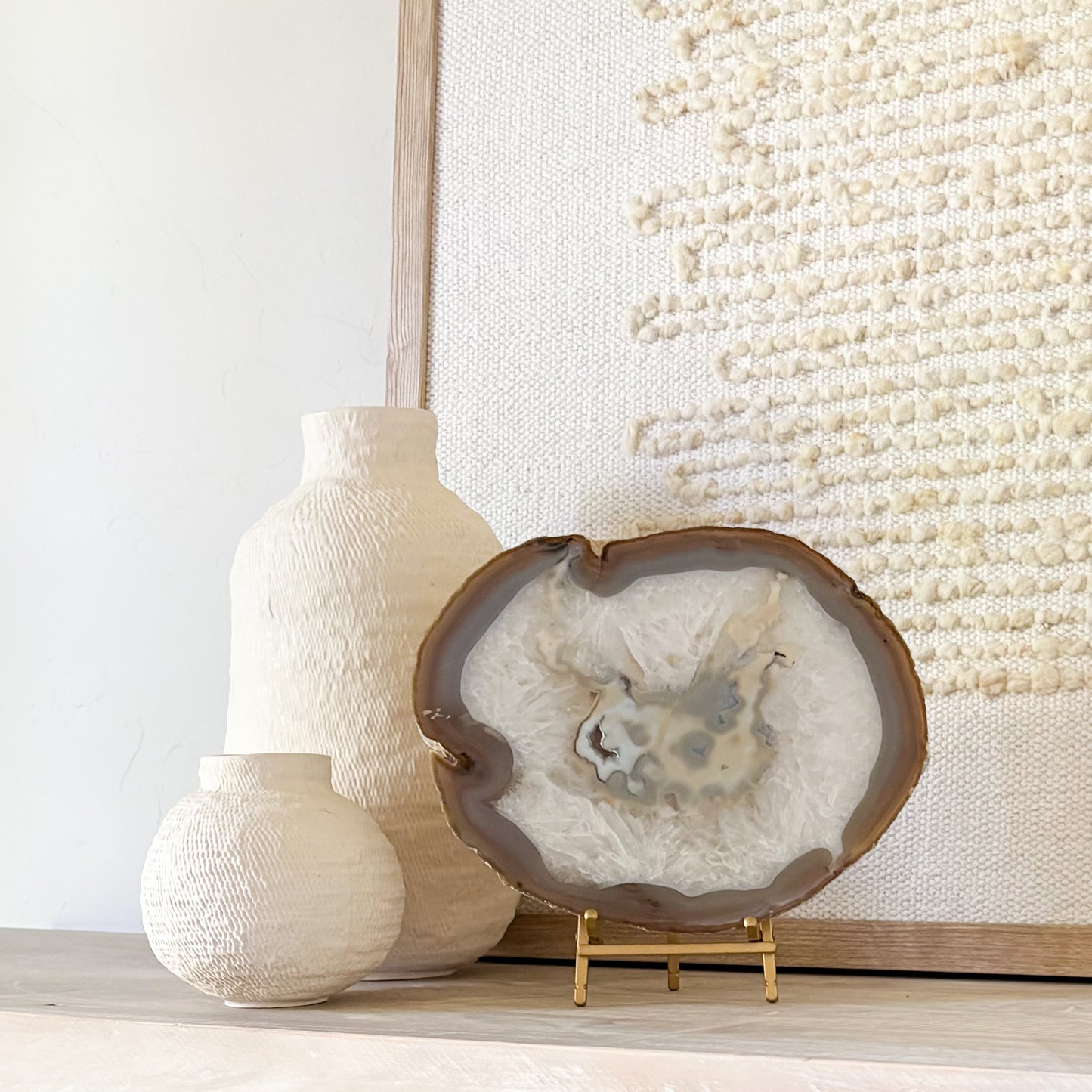 Natural Brazilian agate crystal slice displayed on metal stand elegant decor