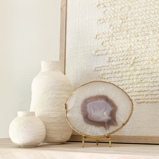 Polished Brazilian agate slice with unique banding on decorative stand for modern home décor.