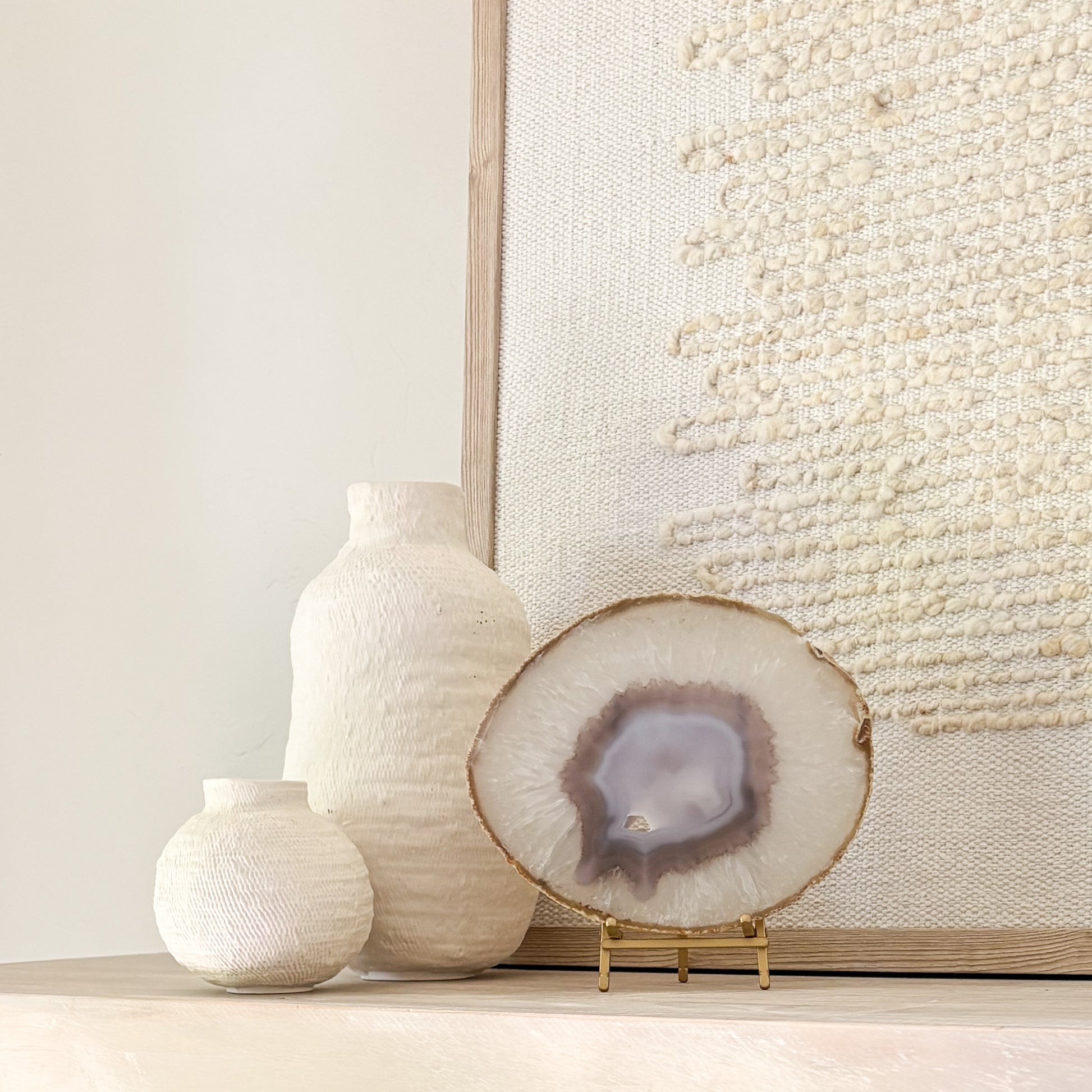 Handcrafted Brazilian agate slice featuring colorful mineral layers displayed on a stylish stand.