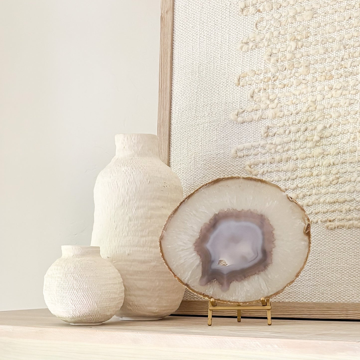 Brazilian agate slice on metal stand displaying natural crystal patterns as elegant home décor accent.