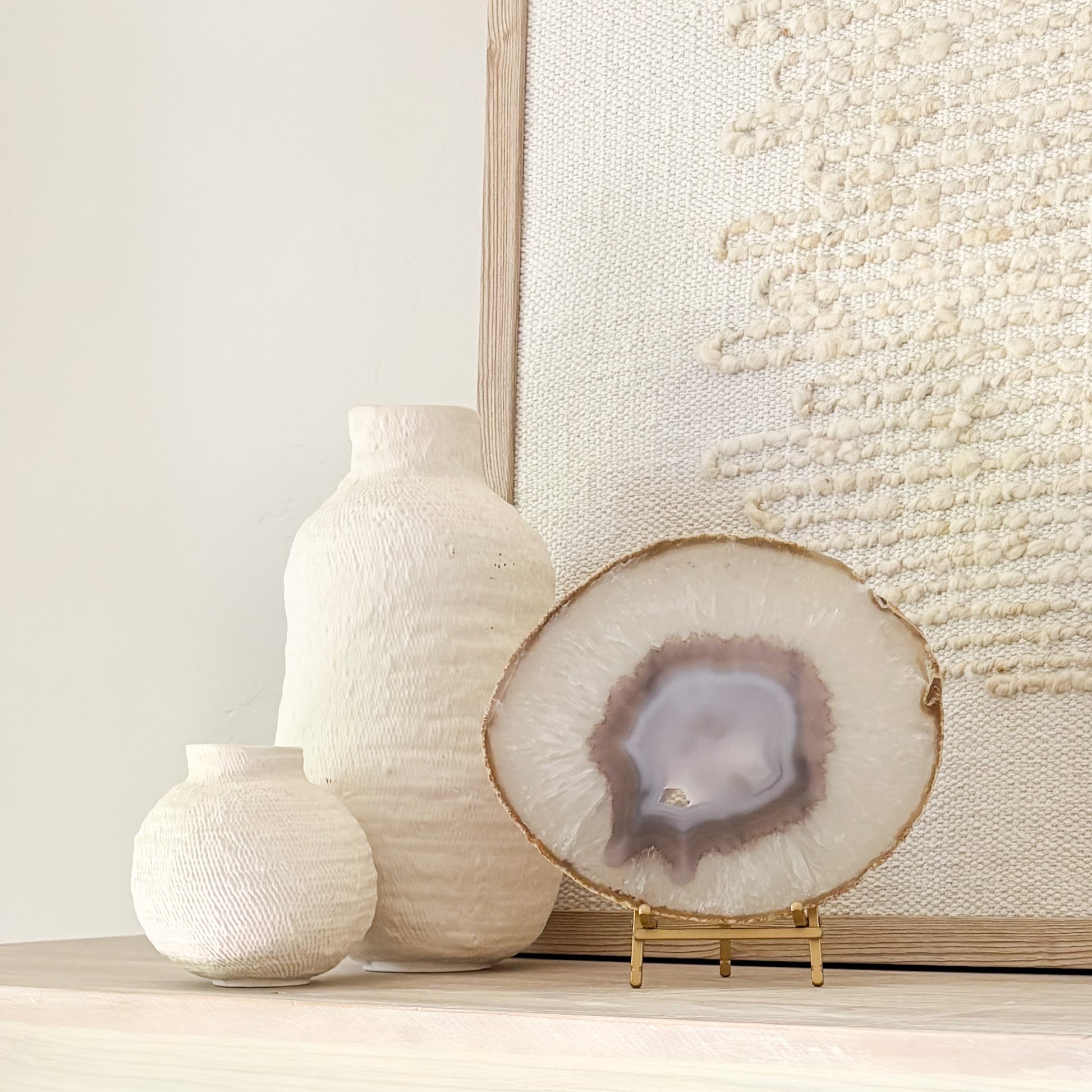 Brazilian agate slice on metal stand displaying natural crystal patterns as elegant home décor accent.