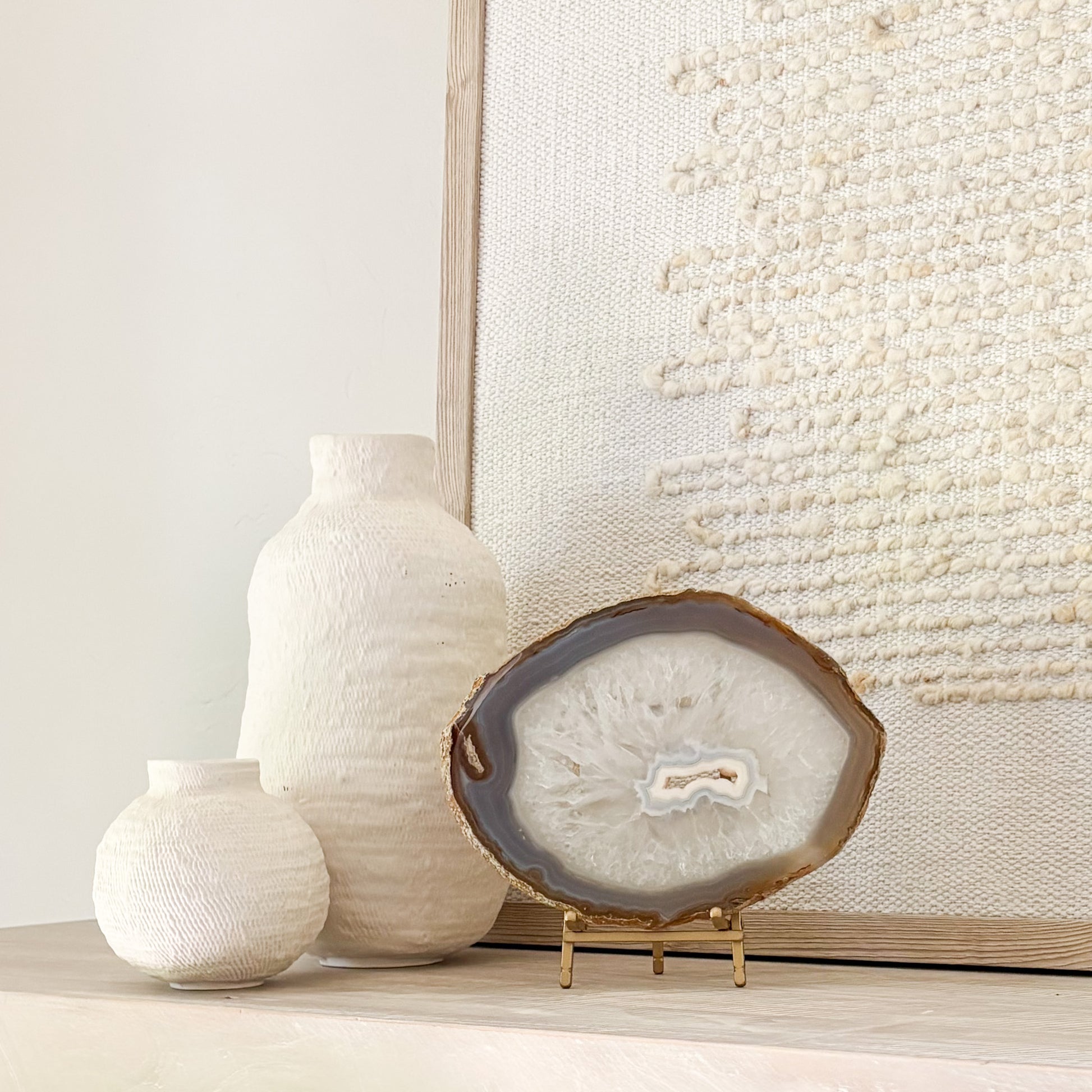Polished Brazilian agate slice with unique banding on decorative stand for modern home décor.