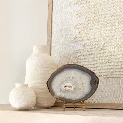 Natural Brazilian agate gemstone slice mounted on stand, perfect for luxury shelf and tabletop décor.