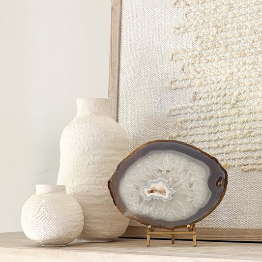 Brazilian agate slice on metal stand displaying natural crystal patterns as elegant home décor accent.