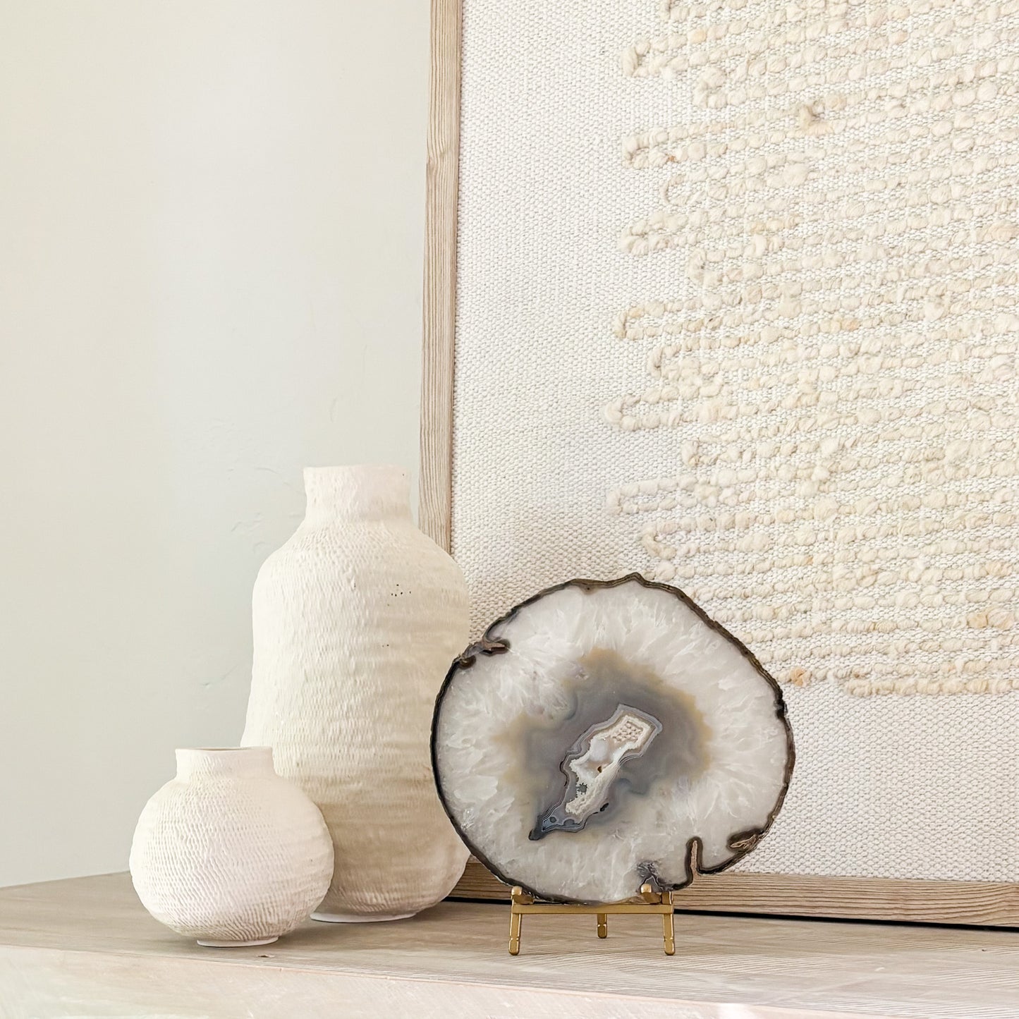 Large Brazilian agate slice sculpture on stand showcasing intricate geological formations for home decoration.