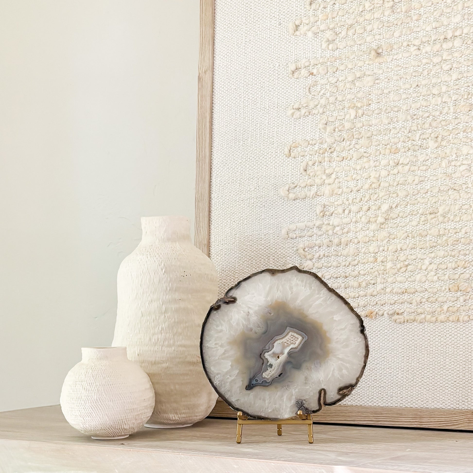 Large Brazilian agate slice sculpture on stand showcasing intricate geological formations for home decoration.