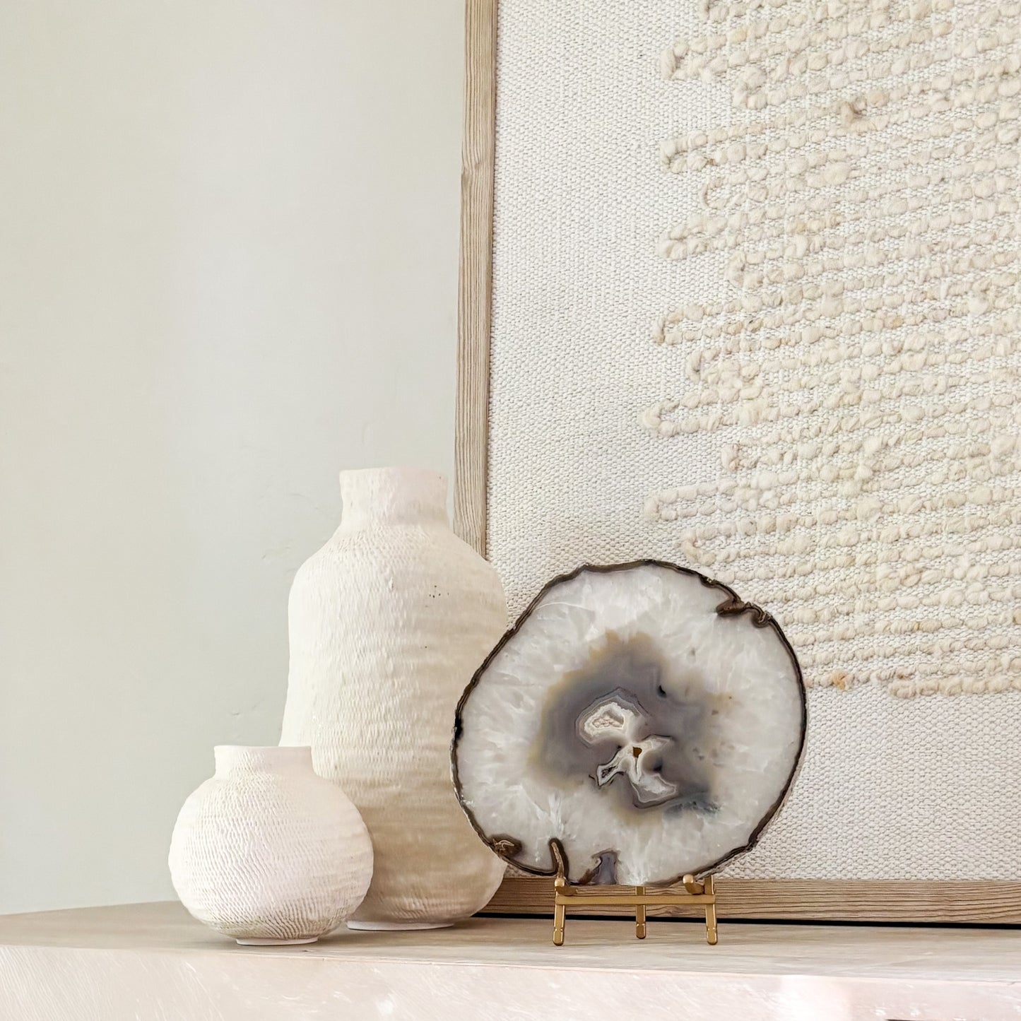Brazilian agate stone slice mounted on metal stand, a striking natural accent for living room décor.