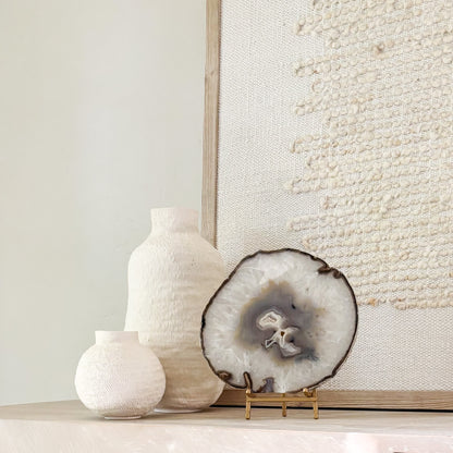 Brazilian agate stone slice mounted on metal stand, a striking natural accent for living room décor.