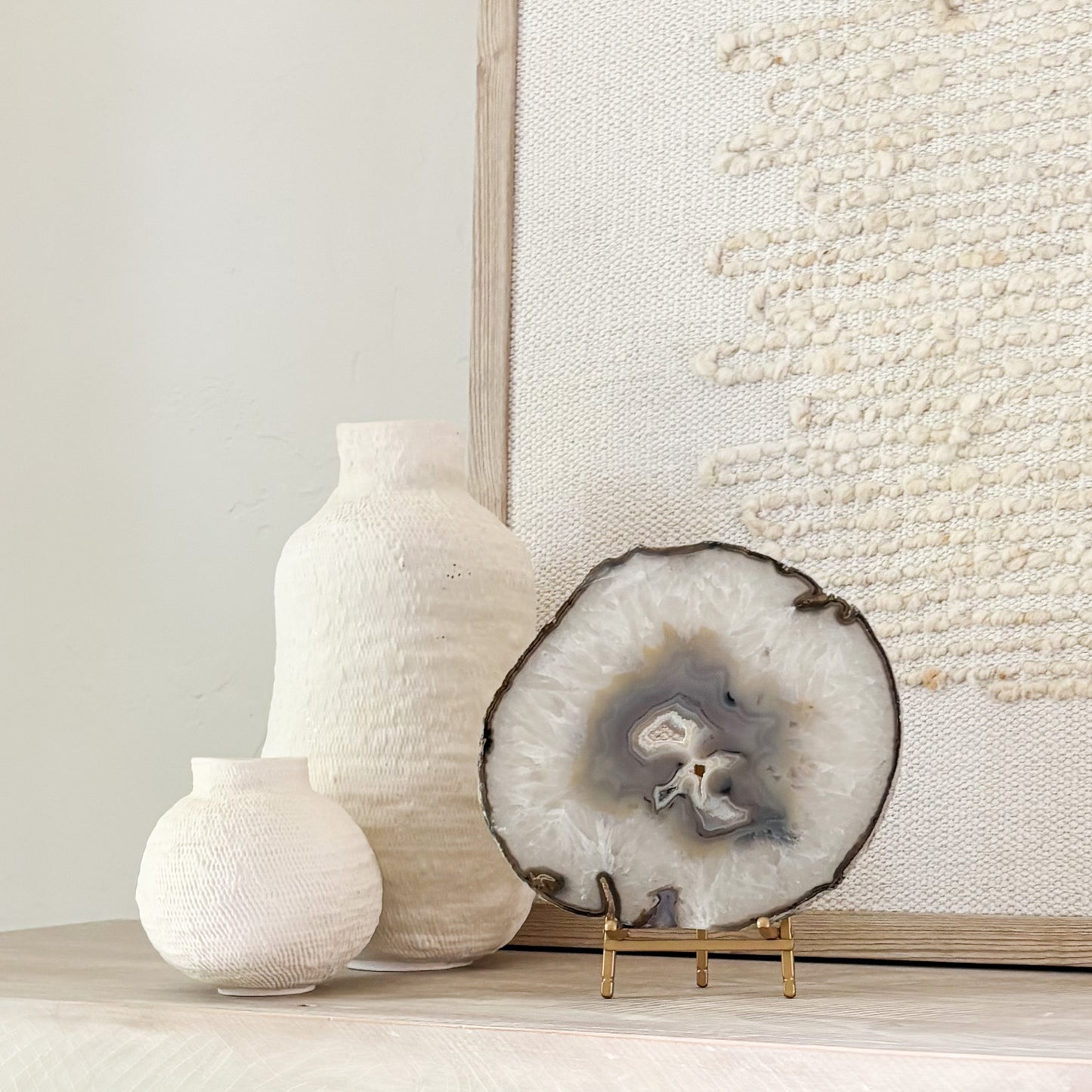Decorative Brazilian agate crystal slice on stand adding natural beauty and sophistication to interior spaces.